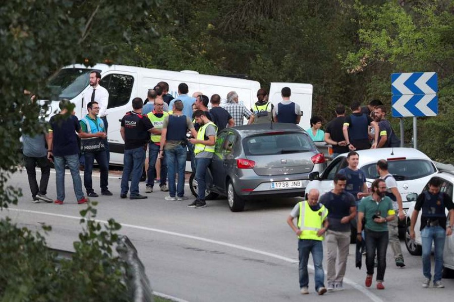 A funeral van is parked in the place where Younes Abouyaaqoub, the man suspected of driving the van that killed 13 people in Barcelona last week, was killed by police in Subirats, Spain on Monday.