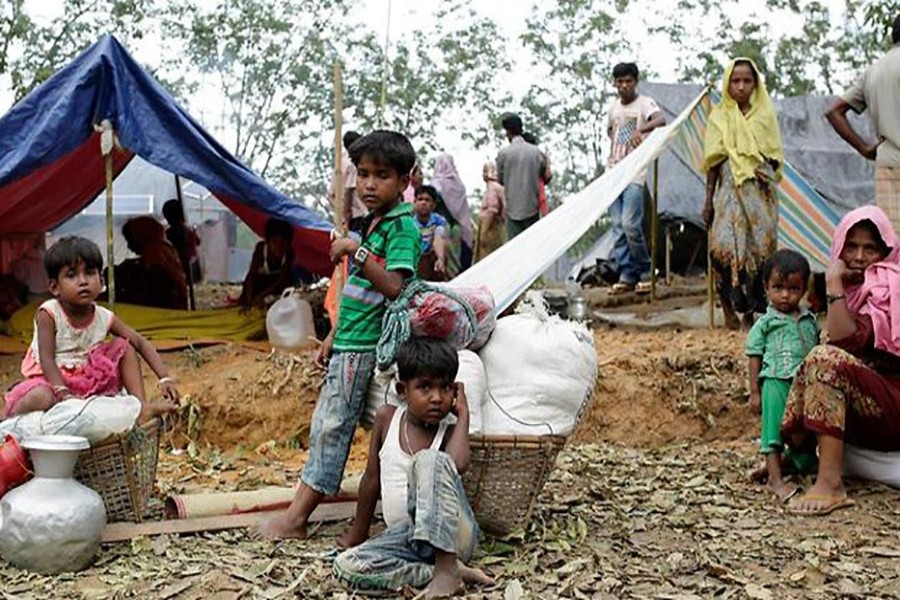 Rohingya family sit in front of their makeshift shelters in a camp in Ukhiya, Cox's Bazar, Bangladesh on Monday last. Photo courtesy: AAP