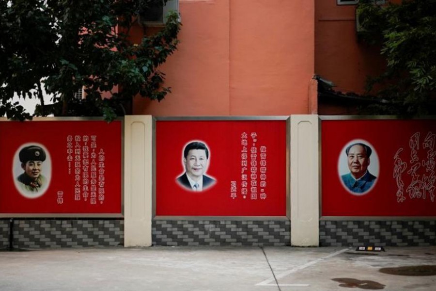 Pictures of Lei Feng, Xi Jinping and Mao Zedong overlook a courtyard in Shanghai, China. – Reuters photo