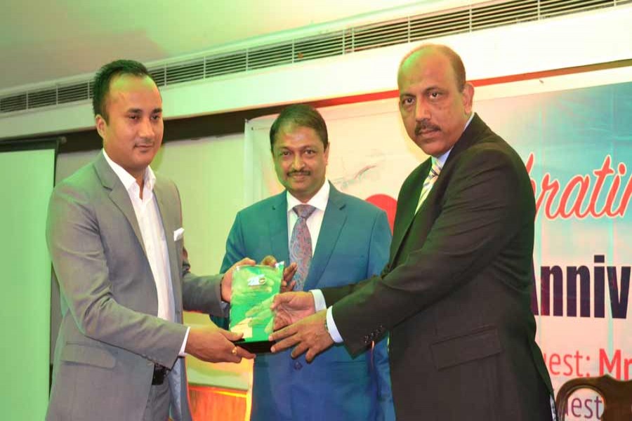 Biman Bangladesh Airlines Director (Marketing & Sales) M Ali Ahsan handing over a crest to a top sales agent in Nepal during a ceremony marking its 43 years of operations on Dhaka-Kathmandu-Dhaka route.