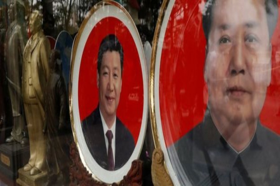 Souvenir plates bearing the images of China’s President Xi Jinping and China’s late Chairman Mao Zedong. Reuters