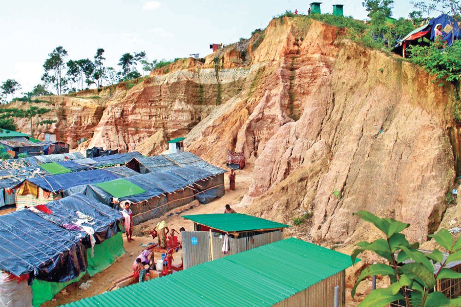 Rohingya refugees live in shanties on hill slopes at Ukhia in Cox's Bazar although a spell of downpour may trigger a landslide that may be devastating. The photo was taken on Thursday. 	— Focus Bangla
