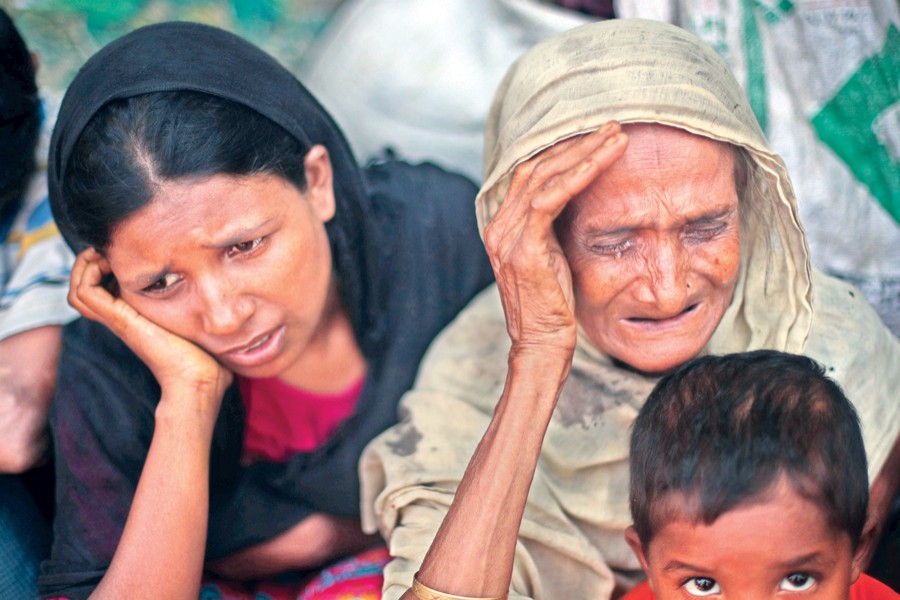 Two helpless Rohingyas, who crossed the border from Myanmar this week, burst into tears at Kutupalong refugee camp in Cox's Bazar on Friday. 	— Reuters