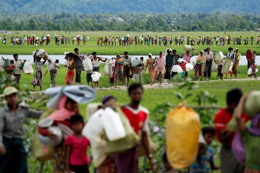 Rohingya refugees walk after they received permission from the Bangladeshi army to continue on to the refugee camps, in Palang Khali, near Cox's Bazar, Bangladesh October 19, 2017. Reuters/File Photo