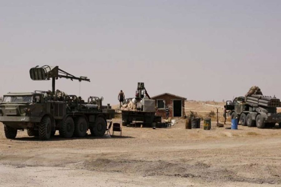 DEIR AL-ZOR: Armoured vehicles of Syrian army seen at a place of Deir al-Zor on Friday.	— Reuters