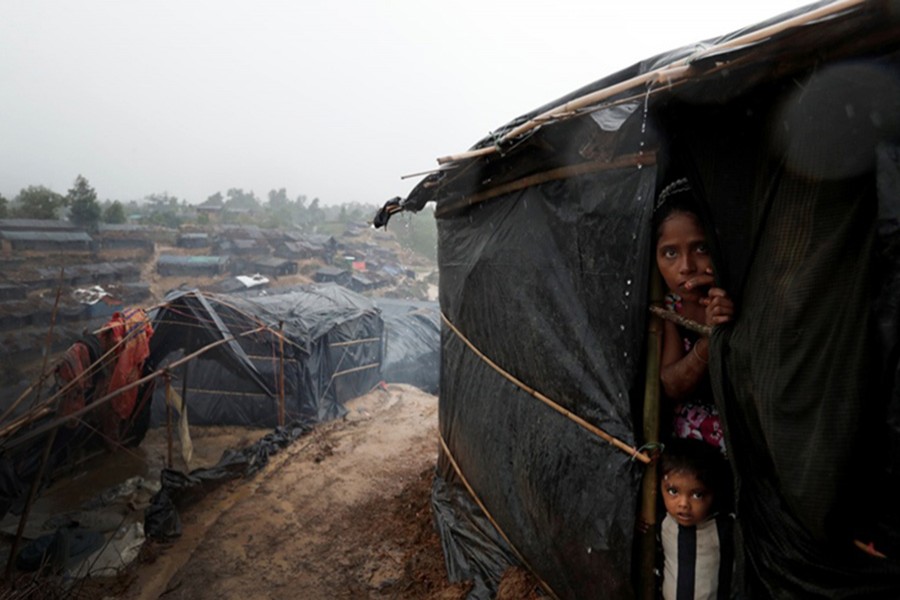 Rohingya refugees look out from a shelter in Cox's Bazar. - Reuters file photo