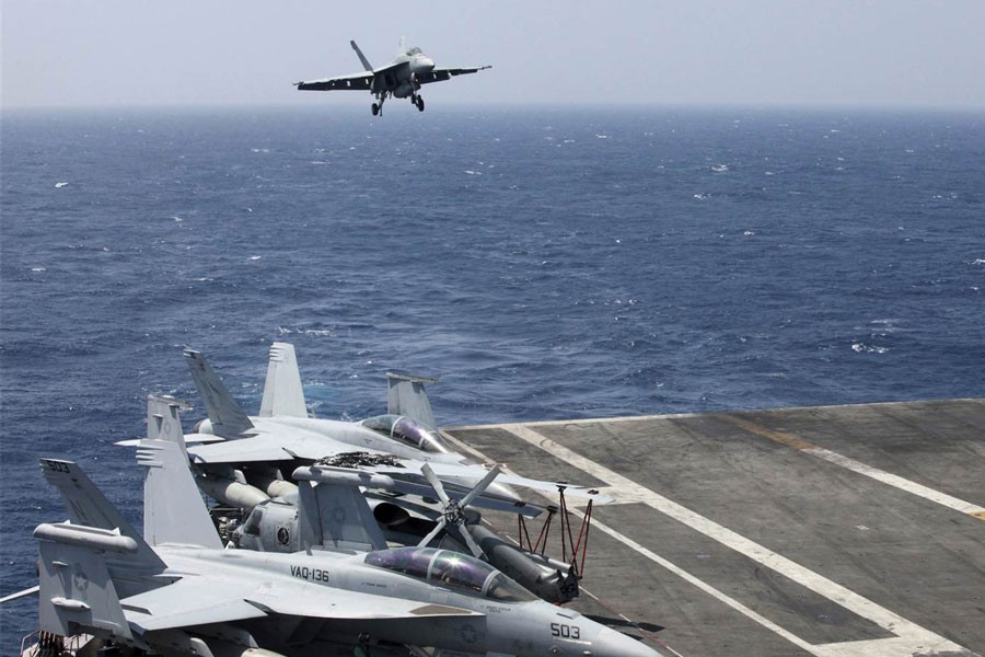 A US Navy F18 fighter jet lands on the US Navy aircraft carrier USS Carl Vinson following a patrol off the disputed South China Sea. (Bullit Marquez / AP)