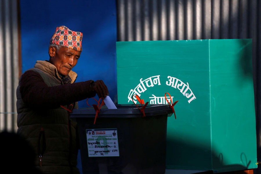 A man casts his vote in a ballot box during the parliamentary and provincial elections at Chautara in Sindhupalchok District on Sunday. - Reuters