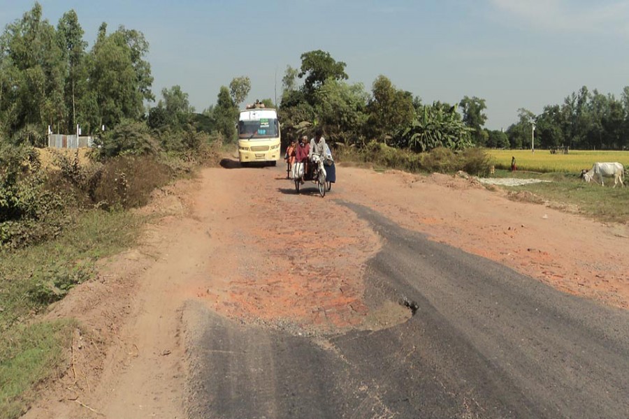 A partial view of the dilapidated Sirajganj-Enayetpur link road in Sirajganj. The photo was taken on Tuesday.	— FE Photo
