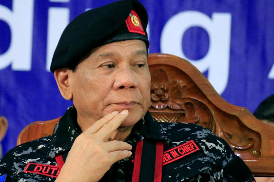 Philippine President Rodrigo Duterte gestures as he attends the 67th founding anniversary of the First Scout Ranger regiment in San Miguel town, Philippines November 24, 2017. (Reuters)