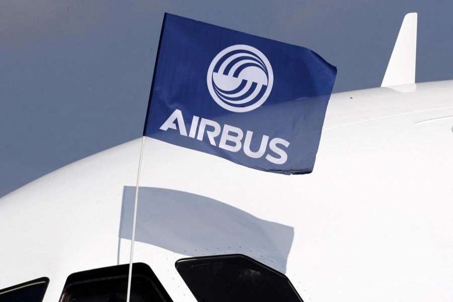 A flight test engineer holds an Airbus Group flag after the first flight of the Airbus A320neo (New Engine Option) in Colomiers near Toulouse, southwestern France, September 25, 2014. Reuters