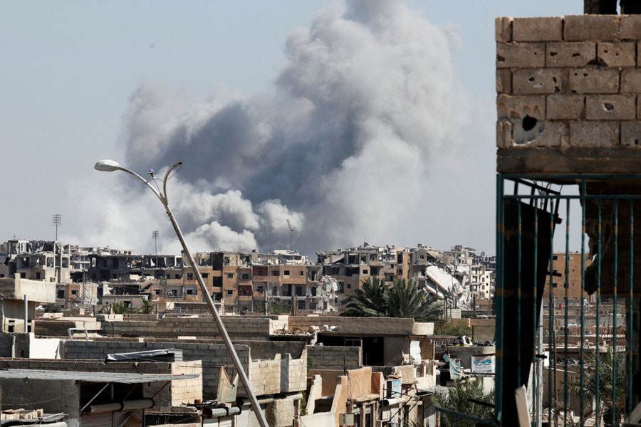 FILE - Smoke rises near a stadium where Islamic State militants were holed up, after an airstrike by coalition forces at the front line in Raqqa, Oct. 12, 2017.  Photo: Voice of America