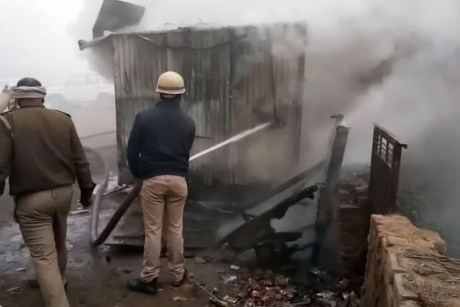 Police trying to douse a fire in violence hit district of Kasganj in Uttar Pradesh. (Times of India)
