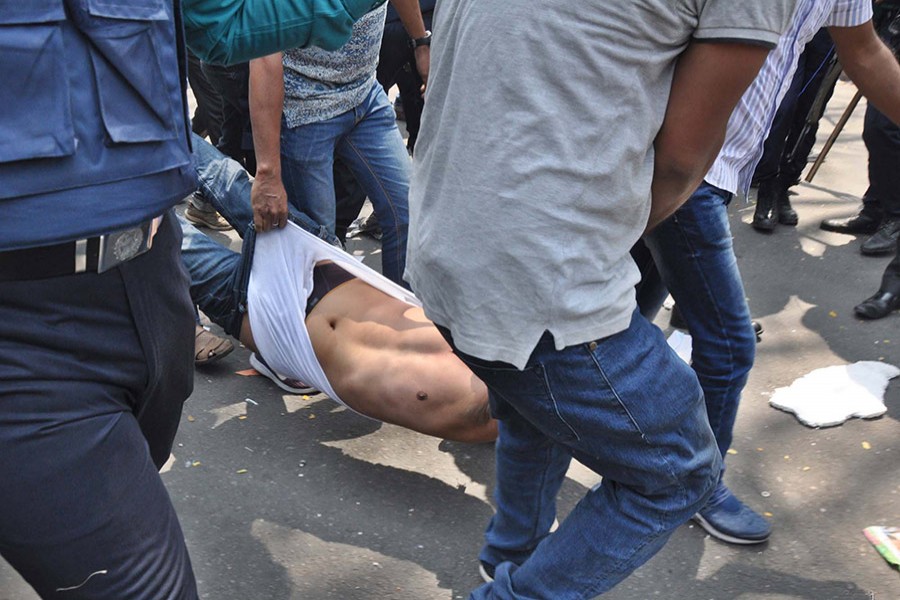 Lawmen drag an activist out of the BNP gathering in front of National Press Club around 11:45am on Thursday. - Focus Bangla photo