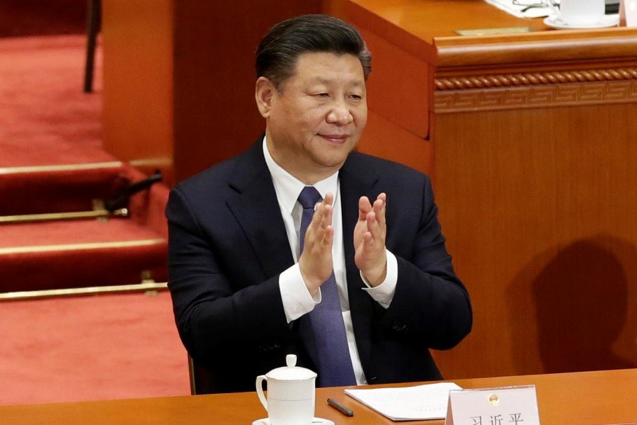 Chinese President Xi Jinping applauds after the parliament passed a constitutional amendment lifting presidential term limit, at the third plenary session of the National People's Congress (NPC) at the Great Hall of the People in Beijing, China March 11, 2018. Reuters