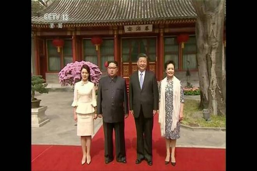 North Korean leader Kim Jong Un, his wife Ri Sol Ju, Chinese President Xi Jinping and his wife Peng Liyuan pose for a photo, in this still image taken from video released on March 28, 2018. North Korean leader Kim Jong Un visited China from Sunday to Wednesday on an unofficial visit, China’s state news agency Xinhua reported on Wednesday.  - Reuters