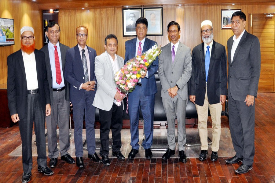 ICMAB president Mohammed Salim, FCMA (fourth from left) presenting a bouquet to Dr. M. Khairul Hossain, Chairman, Bangladesh Securities and Exchange Commission (BSEC) when a delegation, led by the ICMAB president, called on the BSEC Chairman at his office on Monday