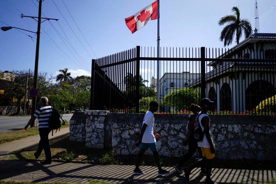 People pass by the Canadian Embassy in Havana Monday. Reuters.