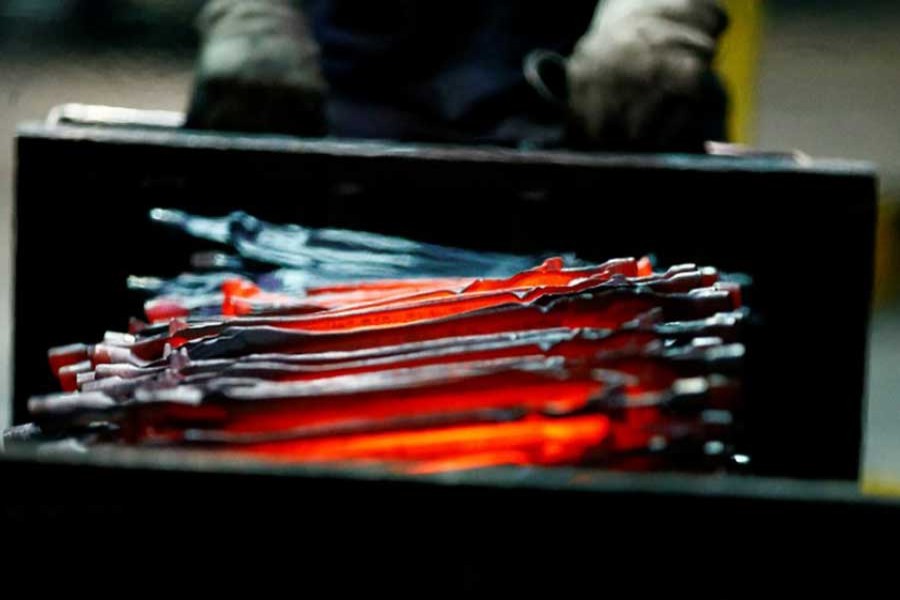 Unfinished pliers still glow after being hot-formed by a hammer at the factory of Knipex, a 130 year-old family-owned pliers and tools maker company in Wuppertal, western Germany, October 25, 2016. - Reuters photo
