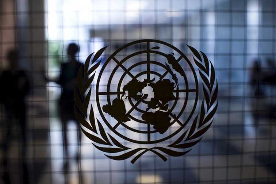 A United Nations logo is seen on a glass door in the Assembly Building at the United Nations headquarters in New York City, September 18, 2015. Reuters/Files