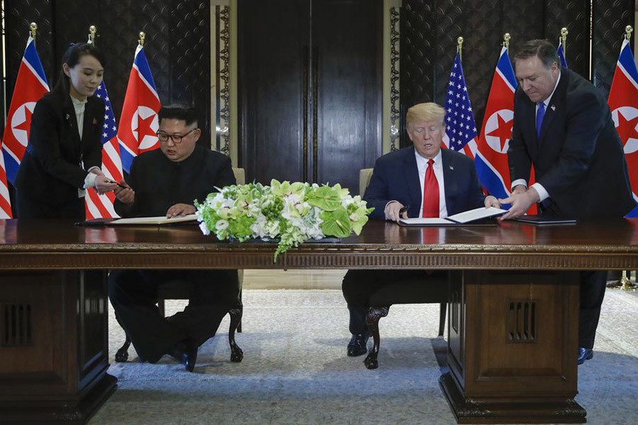 US President Donald Trump and North Korean leader Kim Jong Un prepare to sign a document at a ceremony marking the end of their historic nuclear summit at the Capella hotel on Singapore’s Sentosa island on Tuesday - AP photo