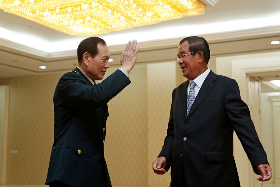 Chinese Defence Minister Wei Fenghe (L) salutes Cambodia’s Prime Minister Hun Sen before a meeting in Phnom Penh, Cambodia June 18, 2018. Reuters.