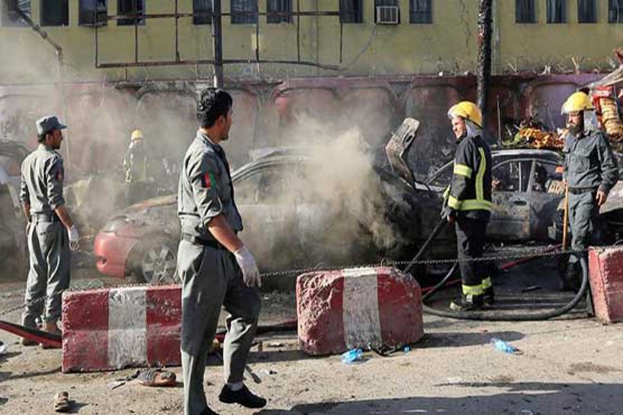 Afghan policemen inspecting the site of a suicide bomb blast in Jalalabad on Monday	— BBC