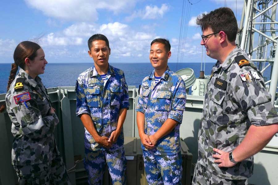 Royal Australian Navy sailors stand with officers from the Chinese Navy aboard the Royal Australian Navy frigate HMAS Newcastle during Australia's largest maritime exercise 'Exercise Kakadu' being conducted off the coast of Darwin in northern Australia, September 8, 2018. Reuters