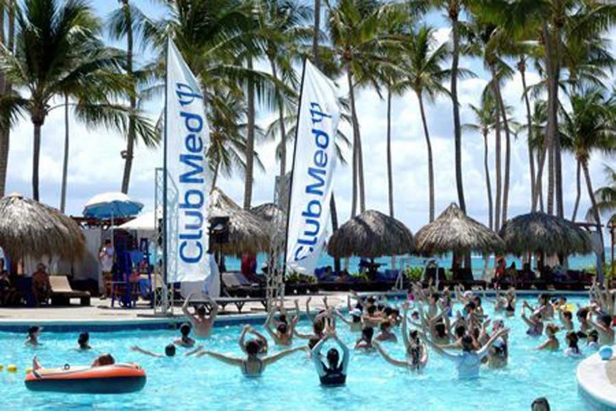 Club Med banners blow in the wind at the swimming pool at the Club Med Punta Cana vacation resort in the Dominican Republic, March 3, 2016. Reuters/Files