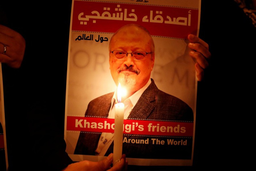 A demonstrator holds a poster with a picture of Saudi journalist Jamal Khashoggi outside the Saudi Arabia consulate in Istanbul, Turkey October 25, 2018. Reuters