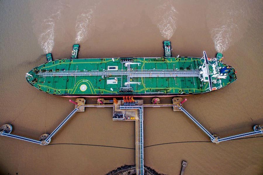 An oil tanker unloading crude at a terminal in Zhoushan, Zhejiang province, China	— Reuters