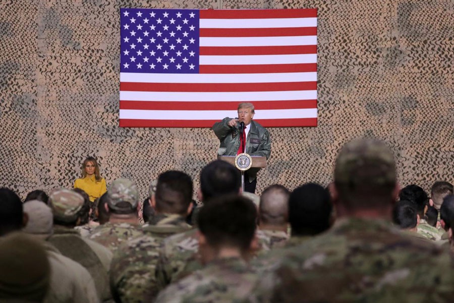 US President Donald Trump, with first lady Melania Trump, delivers remarks to US troops in an unannounced visit to Al Asad Air Base, Iraq, December 26, 2018 - REUTERS/Jonathan Ernst