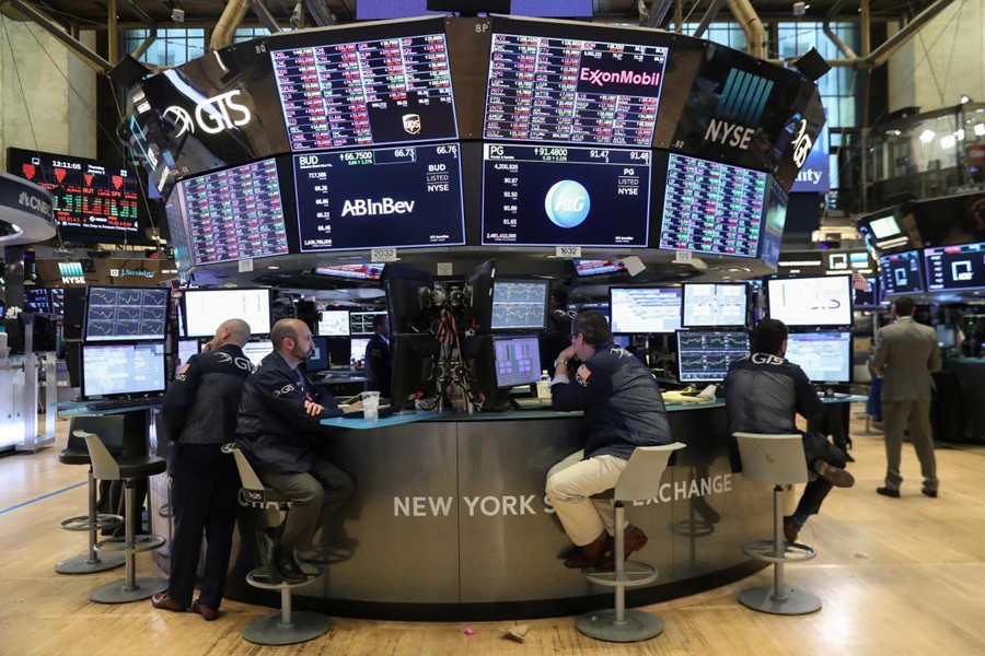 Traders look at price monitors as they work on the floor at the New York Stock Exchange (NYSE) in New York City, New York, US, January 3, 2019. Reuters