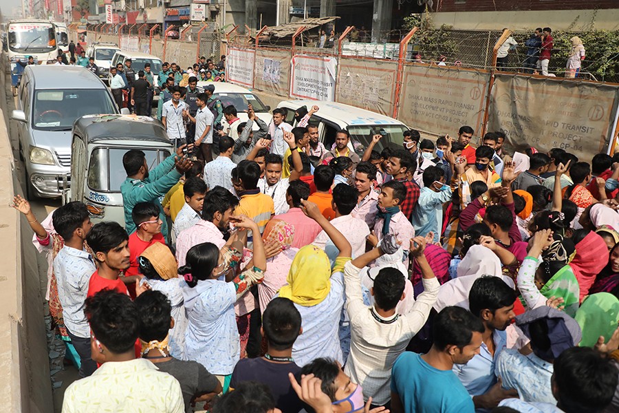 Garment workers staging demonstration at Shewrapara, Mirpur in the city on Thursday demanding cancellation of the 'discriminatory' wage board award announced by the government for them — Collected