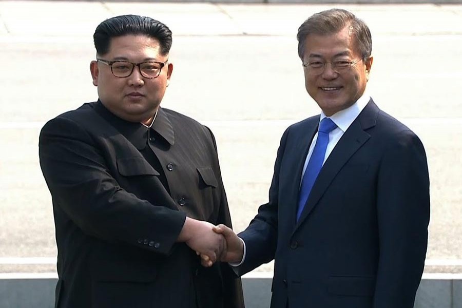 North Korean leader Kim Jong Un and South Korean President Moon Jae-in shaking hands ahead of talks during a historic summit on April 27, 2018 	— File photo
