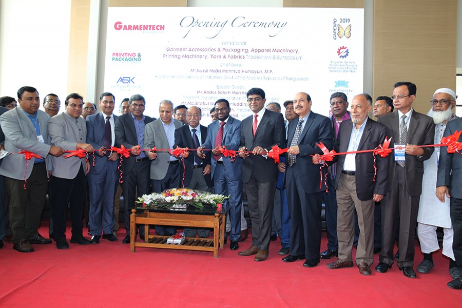 Industries Minister Nurul Majid Mahmud Humayun (sixth from left on the front row) inaugurating the trade shows by cutting a ribbon at the International Convention City Bashundhara on Thursday