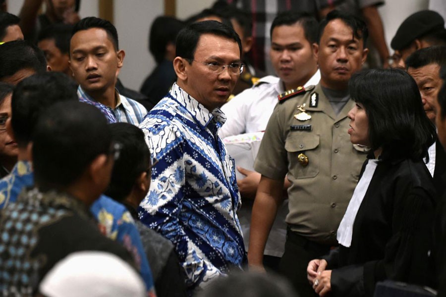 FILE PHOTO: Jakarta's Christian governor Basuki Tjahaja Purnama (L), popularly known as Ahok, speaks to his lawyers after his sentencing during the guilty verdict in his blasphemy trial in Jakarta on May 9, 2017 - REUTERS/Bay Ismoyo/Pool/File Photo