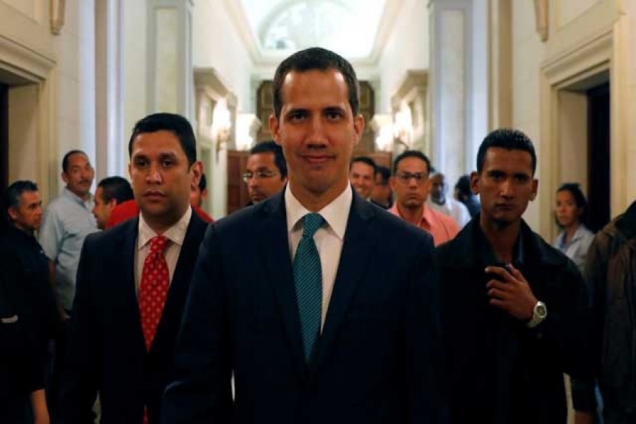 Venezuelan opposition leader Juan Guaido walks at the National Assembly before a news conference in Caracas, Venezuela, February 4, 2019. Reuters