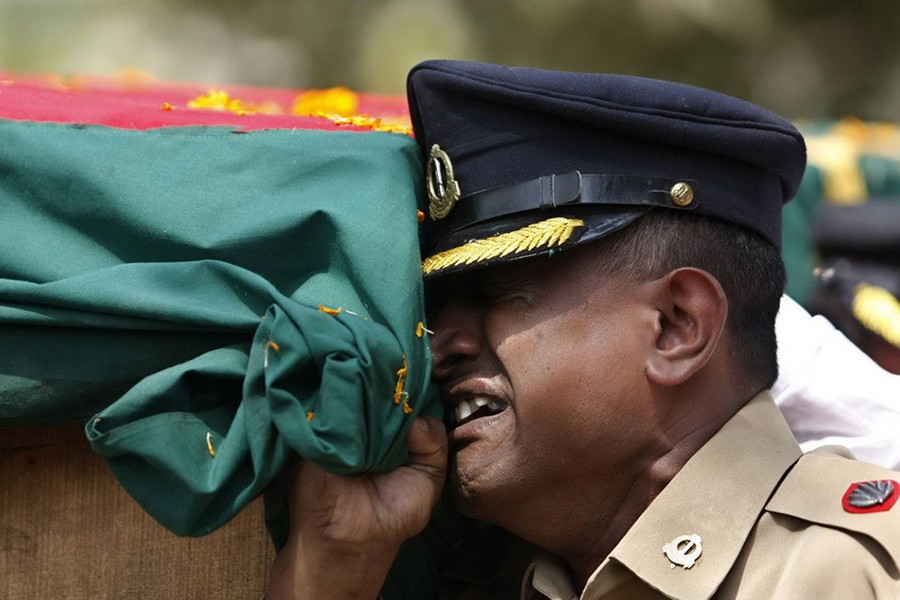 An army soldier cries as he carries the coffin of a Bangladesh Rifles (BDR) officer in Dhaka on March 2, 2009 — Reuters/File