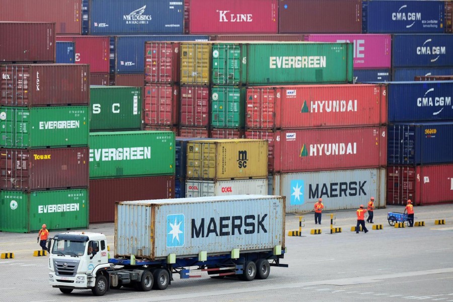 FILE PHOTO: A truck transports a container at a port in Qingdao, Shandong province, China July 11, 2019. REUTERS/Stringer