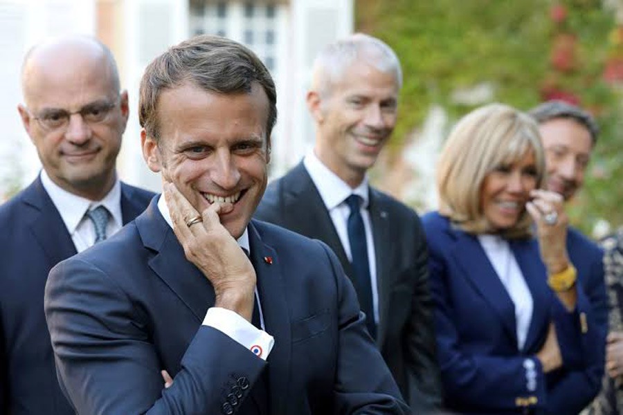 French President Emmanuel Macron, French Education and Youth Affairs Minister Jean-Michel Blanquer, French Culture Minister Franck Riester and Macron's wife Brigitte Macron, speak with pupils visiting the Chateau de By ("By Castle") in Thomery, France, September 20, 2019. Reuters