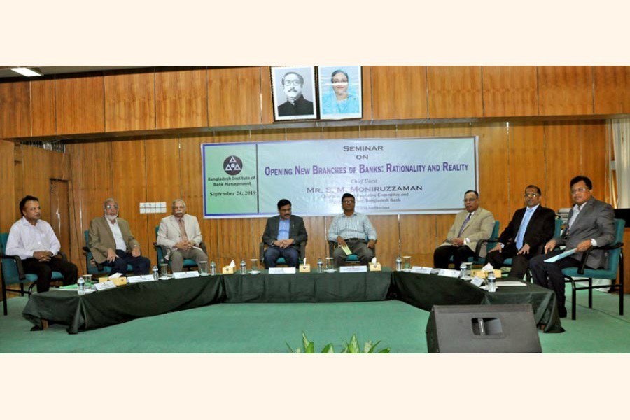 S.M. Moniruzzaman (4th from left), Chairman of BIBM Executive Committee and Deputy Governor of Bangladesh Bank, seen at a seminar titled "Opening New Branches of Banks: Rationality and Reality" held on Tuesday. Helal Ahmed Chowdhury (3rd from right), Supernumerary Professor of BIBM & former managing director of Pubali Bank Limited, seen