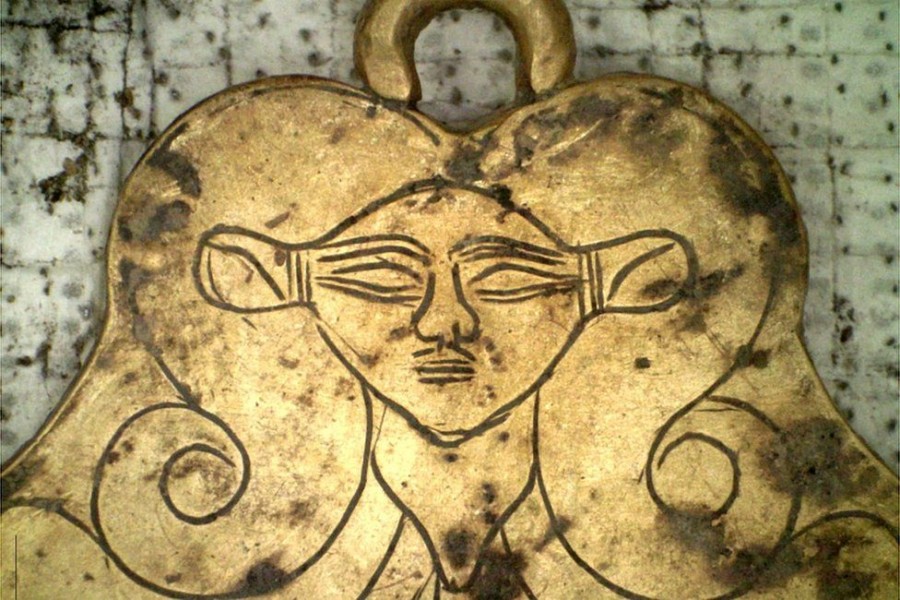 A gold pendant depicted the head of the Egyptian goddess Hathor - a protector of the dead - Photo Courtesy: EPA