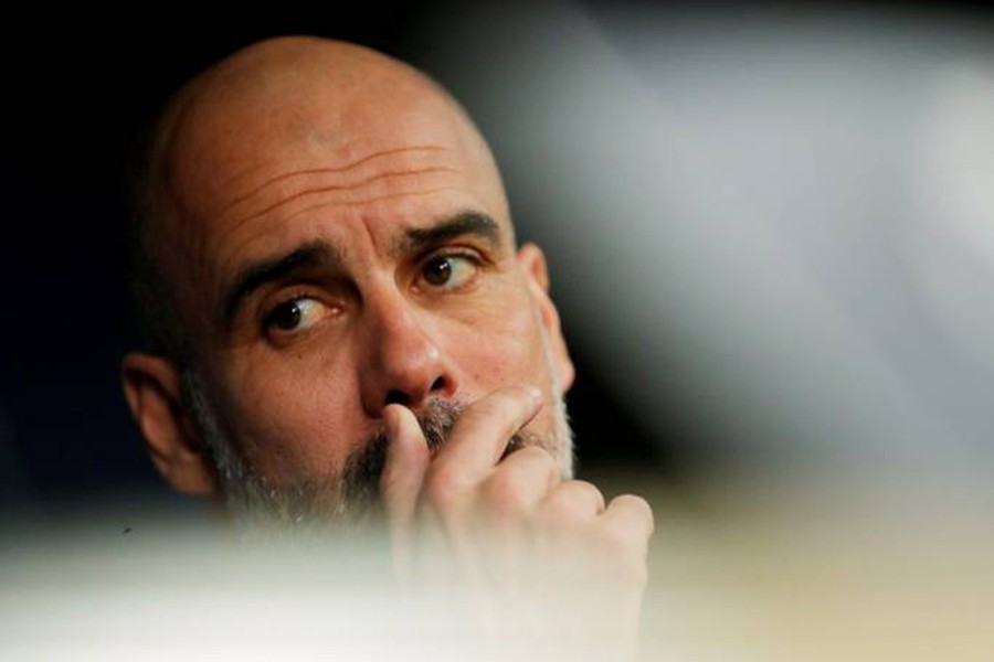 A dejected Pep Guardiola is seen in this undated Reuters photo