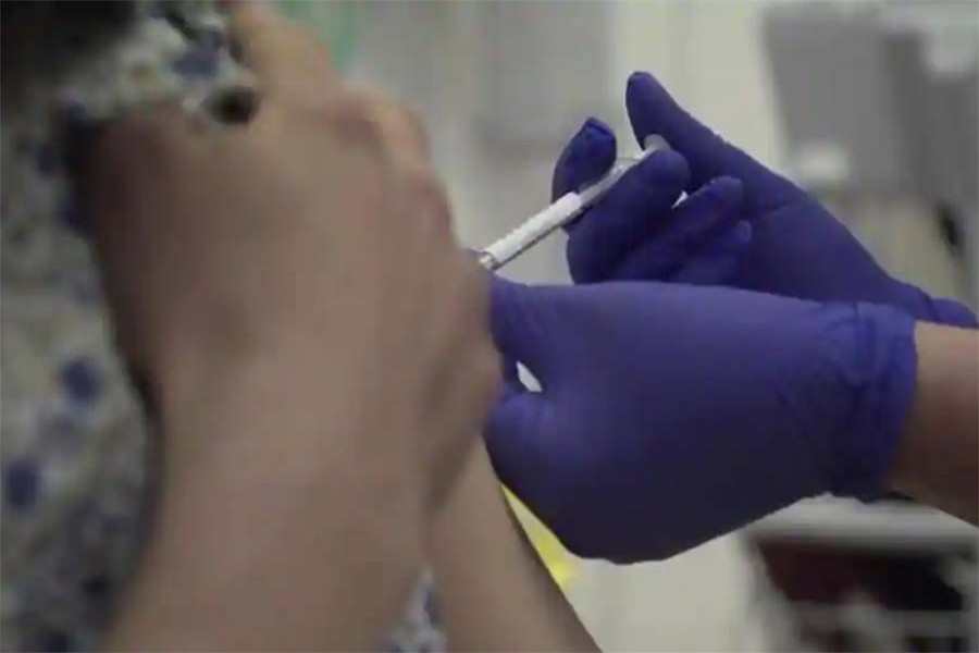 Screen grab taken from video issued by Britain's Oxford University, showing a person being injected as part of the first human trials in the UK to test a potential coronavirus vaccine, untaken by Oxford University, England. (AP)