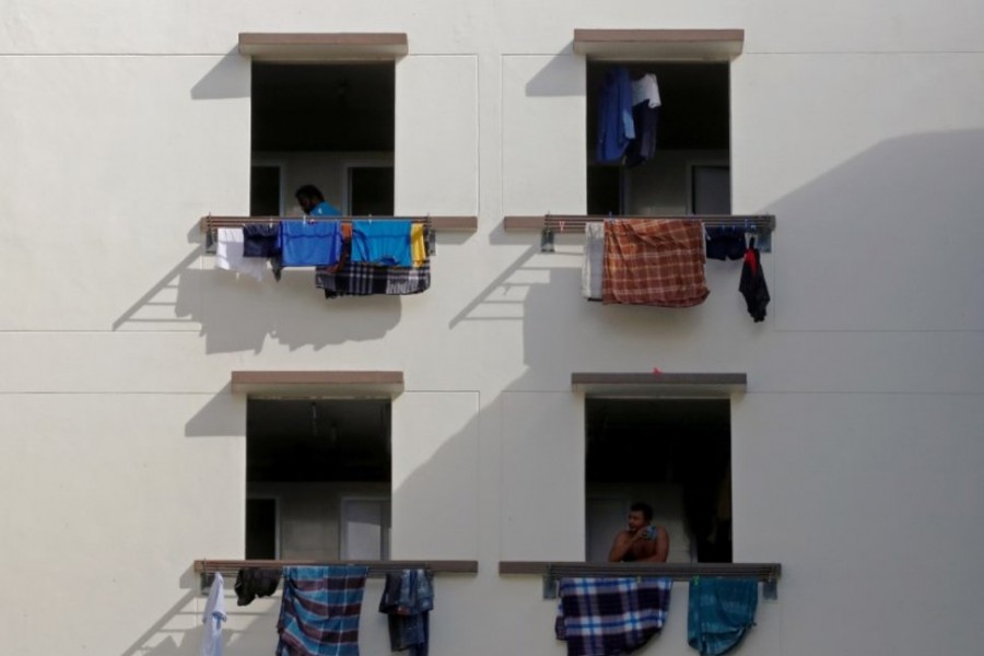 Migrant workers look out of windows in a dormitory, amid the coronavirus disease (COVID-19) outbreak in Singapore on May 15, 2020 — Reuters/Files