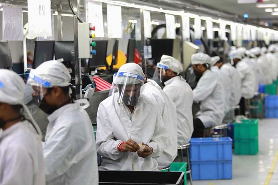 Workers performing duties at an assembly line of mobile phones at Lava International Limited's manufacturing plant, during coronavirus outbreak in Noida of India this months –Reuters Photo