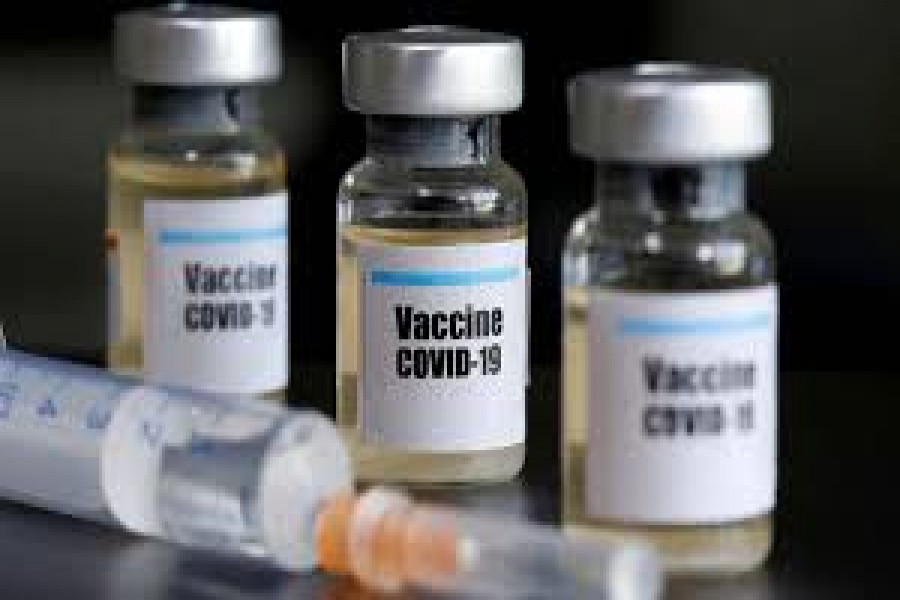 FILE PHOTO: Small bottles labeled with a "Vaccine COVID-19" sticker and a medical syringe are seen in this illustration taken taken April 10, 2020. REUTERS/Dado Ruvic/File Photo   