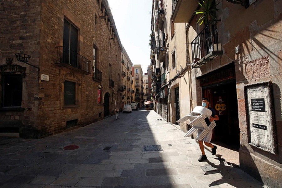 A staff member of a bar carries chairs, amid the coronavirus disease (Covid-19) outbreak, in the Gothic quarter in Barcelona, Spain, July 27, 2020 — Reuters/Files