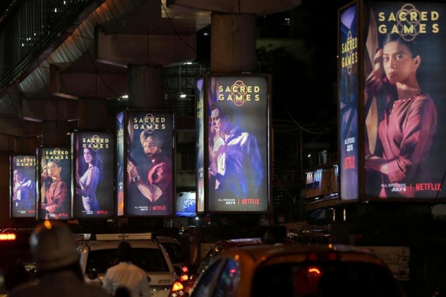 Traffic moves on a road past hoardings of Netflix television series "Sacred Games" in Mumbai, India, July 11, 2018. REUTERS/Francis Mascarenhas